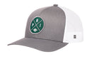 The Haka Hat Philadelphia Trucker Hat | Black PHI X Football Snapback by Haka Hat features a black and white design with a green circular patch on the front, displaying crossed lines, the letters “P,” “H,” and “I,” and a small football at the bottom. The classic white mesh back provides breathability for comfort.