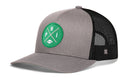 Introducing the Haka Hat Philadelphia Football Trucker Hat | Kelly Green PHI X Snapback—a gray and black trucker hat featuring a green circular patch on the front with PHI and football graphics. This hat by Haka Hat offers black mesh back panels and a classic snapback closure for adjustable comfort.
