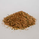 A small pile of Dead Rooster Co Old Timers All-Purpose Dry Rub by Dead Rooster Co. forms a versatile seasoning blend on a plain white surface.