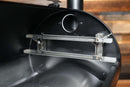Interior of a black barrel smoker showing a Pimp My Grill® Gen2 Slide-Out Rack System - 2 Racks for the Pit Boss Austin XL with two stacked metal rails installed on the side wall.