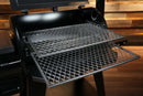 Two stacked metal diamond-mesh Pimp My Grill® Gen2 Slide-Out Rack System - 2 Racks extended outward from the open lid of a Pit Boss Pro 850 pellet grill.