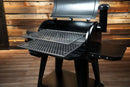 A black pellet grill with its lid open, featuring the Pimp My Grill® Gen2 Slide-Out Rack System - 2 Racks with two stacked, slide-out metal grid racks extending from the cooking chamber.
