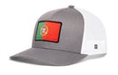 Haka Hat Portugal Flag International Trucker Hat, a gray snapback with a white mesh back and a rectangular Portuguese flag patch on the front.