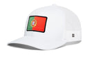 Haka Hat Portugal Flag International Trucker Hat, a white trucker hat with a mesh back and a rectangular Portugal flag patch on the front.