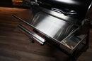 Pimp My Grill® Tactical Stainless Folding Front Shelf attached to a Recteq RT-700, featuring an integrated paper roll holder and a side utility tray for added prep space.