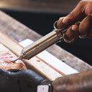 in use recteq meat injector for marinades and flavor injection for brisket and poultry