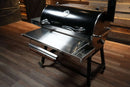 Pimp My Grill Tactical Stainless Folding Front Shelf for Recteq RT-700 / RT-680, a stainless steel shelf featuring a paper towel holder, a side accessory tray, and grill prep space.