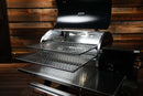 Two stainless steel Pimp My Grill® Gen2 Slide-Out Rack System racks extended outward from a Recteq RT-800 / Deck Boss 800 with its lid open.