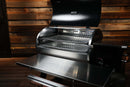 A stainless steel Recteq RT-800 / Deck Boss 800 pellet grill with the lid open, revealing two stacked, slide-out Pimp My Grill® Gen2 Slide-Out Rack System metal grill racks inside.