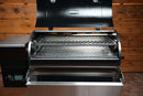 A Recteq Patio Legend 410 pellet grill equipped with a Pimp My Grill® Gen2 Slide-Out Rack System with two stacked metal cooking racks shown with the lid open.
