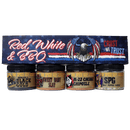 Four jars of The Spice Guy's Black Gold, Baby Slay, M-22 Cherry Chipotle, and SPG seasonings sit in front of The Spice Guy Red, White & BBQ Box—an ideal gift for grill masters with its patriotic eagle graphic.