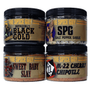 The Spice Guy Red, White & BBQ Box includes four spice jars—Black Gold, SPG, Sweet Baby Slay, and M-22 Cherry Chipotle—each with a unique label design. Perfect BBQ seasoning blends for grill masters from The Spice Guy brand.