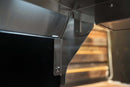 Close-up of a stainless steel Pimp My Grill® Tactical Stainless Folding Front Shelf for Recteq RT-700 / RT-680 mounted to a grill.
