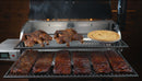 Two Pimp My Grill® Gen2 Slide-Out Rack System - 2 Racks for Recteq RT-700 / RT-680 filled with cooked whole chickens, a pie, and several racks of ribs inside a smoker.