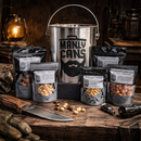 DDR BBQ Supply Manly Cans nut gift set featuring five snack pouches and a metal bucket on a rustic wooden table