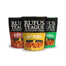 The Rufus Teague Crunchin' Corn Variety Pack includes Barbecue Throwdown, Hot Honey, and Ranch roasted corn kernels in colorful packaging that highlights their bold flavors against a crisp white background.