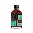 A bottle of Rufus Teague Diablo Limonajo BBQ Sauce shown from the back, with a green and black label featuring nutrition facts, heat meter, product description, and barcode—perfect for pairing with spicy dishes.