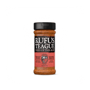 Rufus Teague Fish Rub seafood seasoning features a black lid, a red and black label with the Rufus Teague brand name and a fish illustration. This gluten-free blend is perfect for elevating your favorite seafood dishes.