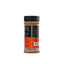 A Rufus Teague Steak Rub bottle with a black lid is shown from the back, featuring nutritional info and text on a black and orange label. The brown, coarse seasoning inside is a gluten-free steak rub by Rufus Teague.