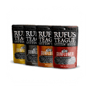 Four pouches of Rufus Teague Sunflower Seeds Variety Pack are arranged diagonally on a white background, featuring the bold BBQ flavors of Pitmaster, Smoky NY, Slow Burn BBQ, and BBQ Throwdown.