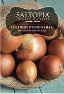 A burlap sack spills yellow onions onto a teal wooden surface. Text reads: SALTOPIA Infused Sea Salts, BEN THERE, D'ONION THAT Onion Salt, small-batch onion infused sea salt.