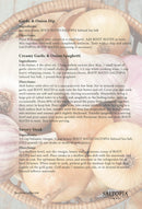 A recipe card presents three dishes using garlic, onion, and honey, with ingredients and directions over a basket of garlic bulbs. Each recipe features SALTOPIA Infused Sea Salts' ROOT MATES Garlic & Onion Salt. SALTOPIA’s logo is at the bottom right.