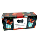 The Saltopia Kitchen Favorite Flavors Gift Set: COOKS SURVIVAL KIT by SALTOPIA Infused Sea Salts features kitchen essentials and infused sea salt blends, perfect for cooks of any skill level. The box depicts utensils, cutting boards, and greenery on a black background.