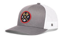 Introducing the Haka Hat San Francisco Football Trucker Hat | Black SF X Snapback by Haka Hat—a black and white trucker hat featuring a round SF X embroidered patch with crossed Golden Gate bridge and goal post symbols, the letters S and F, and a football at the center. The back has breathable white mesh, making this Haka signature snapback the perfect choice for any fan.
