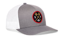 A black SF X snapback from Haka Hat, the San Francisco Football Trucker Hat features an embroidered patch with a yellow bridge, crossed bats, and the letters S and F above a football—capturing classic Haka signature trucker style.