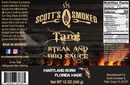 Label for Scott’s Smoked Q Tang North Carolina-Style Vinegar BBQ Sauce from Scott’s Smoked Q, featuring grilled steak, flames, ingredients, nutrition facts, social media links, and the slogan “Maryland Born • Florida Made” with a map of Florida. Enjoy the bold flavor of this savory finishing sauce inspired by classic North Carolina-style barbecue—a tangy vinegar BBQ sauce sure to elevate any meal.