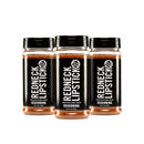 Three bottles from the Redneck Lipstick 3-Pack Smoky Sweet & Spicy Seasoning Blend are arranged in a row against a white background, each featuring black labels and black lids.