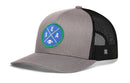 A Royal Blue Haka Hat Seattle Football Trucker Hat by Haka Hat features a black mesh back and showcases a green and blue circular SEA X logo with a football at the center, capturing the signature Haka 5.0 trucker style.
