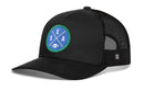 Introducing the Haka Hat Seattle Football Trucker Hat | Royal Blue SEA X Snapback: This stylish black trucker hat by Haka Hat features a royal blue and green round patch on the front, displaying crossed lines, the letters S, E, A, and a small football icon. Classic SEA X green and blue accents add team spirit, while black mesh on the back and sides offers breathable comfort.