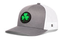 Black and white mesh Haka Hat Shamrock Trucker Hat snapback featuring a round patch with a green shamrock on the front.
