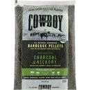 A twenty-pound bag of Cowboy 20 Lb. Charcoal & Hickory Barbeque Pellets featuring a label with a cowboy on horseback, grilling icons, and text indicating suitability for pellet grills.