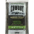 A clear bag of Cowboy 20 Lb. Charcoal & Hickory Barbeque Pellets, featuring labels about natural hardwood and pairing suggestions for beef, pork, chicken, and turkey.