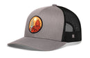 Crafted by Haka Hat, the Haka Hat Southwest Sunset Trucker Hat | Desert Snapback features a stylish gray and black design with a mesh back and a round patch depicting a cactus, mountains, and an orange sun—perfectly capturing the vibe of the Southwest.