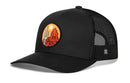 Introducing the Haka Hat Southwest Sunset Trucker Hat — a black mesh snapback from Haka Hat, showcasing a round patch with a vivid desert scene featuring a cactus, red rocks, and a sun. This Desert Snapback perfectly embodies the adventurous spirit of the Southwest Sunset Trucker Hat collection.
