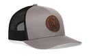 Sure! Here’s a rewritten sentence using your product data: The Haka Hat Southwest Sunset Trucker Hat is a grey and black snapback featuring a faux leather circular patch with a desert scene of cacti and a crescent moon, perfect for capturing those signature Southwest sunset vibes.