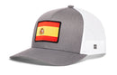 Gray and white Haka Hat Spain Flag International Trucker Hat featuring a rectangular Spain flag patch on the front.