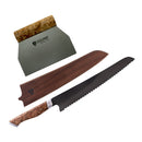The Steelport Knife Co. 3-Piece Baker Set from Steelport Knife Co. includes a handcrafted serrated bread knife with a wooden handle, a matching wooden sheath, and arrives in distinctive STEELPORT branded packaging—all beautifully presented on a white background.