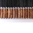 A row of Steelport Knife Co. 6" Chef Knives, featuring polished, patterned wooden handles and gleaming metal blades, neatly aligned against a white background.