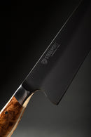 Close-up of the Steelport Knife Co. 8" Chef Knife, distinguished by its wooden handle and dark blade with the Steelport Knife Co. name engraved, showcased against a black background—an elegant representation of traditional forging celebrated for outstanding edge retention.