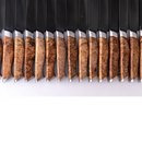 A row of Steelport Knife Co. 8" Chef Knives—featuring black blades and polished, textured wooden handles, expertly crafted by Steelport Knife Co. using traditional forging techniques for exceptional blade edge retention—is neatly aligned against a white background.