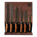 Six Steelport Knife Co. kitchen knives with patterned wooden handles are displayed upright on a dark wooden magnetic knife block. The American-made Steelport Knife Co. Full Kitchen Set features high-carbon steel knives in varying sizes and blade shapes, arranged from largest to smallest from left to right.