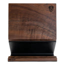 The Steelport Knife Co. Knife Block by Steelport Knife Co. features a wooden walnut construction with a dark top half and a black lower section. This magnetic knife block displays the Steelport logo in the upper right corner and additional branding on the front base, offering an elegant and stylish solution for kitchen knife storage.
