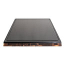 The Steelport Knife Co. SteelCore™ 2-in-1 Walnut Cutting Board, measuring 18"x12", is a rectangular black dual-sided board with a wooden walnut edge and the Steelport logo prominently displayed at the center of the front. Its smooth, slightly raised surface adds to its elegant appearance against a white background.