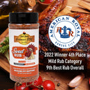A bottle of Hickman's BBQ Sweet Natural Gluten Free BBQ Rub 9.4 oz is shown in front of grilled chicken, with the American Royal Kansas City logo highlighting its 2022 awards: 4th place Mild Rub and 9th Best Rub Overall.