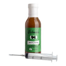 A bottle of Hickman's Divine Swine Pork Injectable Marinade with Injector from Hickman's BBQ, with a plastic marinade injector syringe in front—ideal for infusing bold flavors into your smoked pork.