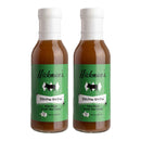 Two bottles of Hickman's BBQ Divine Swine Pork Injectable Marinade (Pack of 2) feature distinctive green labels, white caps, and bold black-and-white pig graphics on the front—an ideal choice for BBQ enthusiasts eager to infuse their smoked pork with rich moisture and flavor using this premium marinade from Hickman's BBQ.